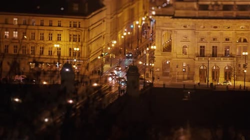 Aerial view of the night Prague - dim street lights and busy traffic on the streets. Slow-motion, pa