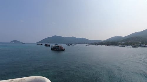 Time-lapse from back of boat leaving harbor on tropical island
