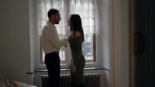 Couple Arguing in Apartment Near Window During Day