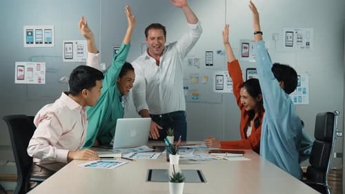 Diverse Team Celebrates Success in Modern Office