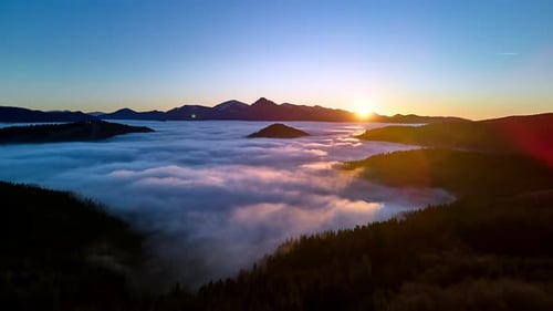 Stunning Sunset Drone Hyperlapse of Rolling Fog Sea Over Forest Valley