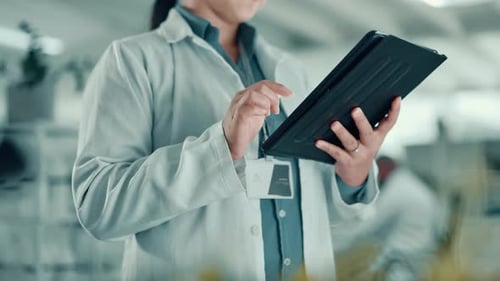 Adult Using Tablet in Modern Lab Environment