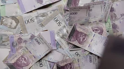 Scattered Venezuelan Paper Money on Flat Surface