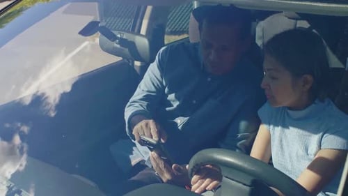 Mature Couple Using Smart Phone in Sunny Car 4549 Years