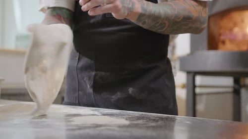 Pizzaiolo Tossing Dough in the Kitchen of Pizzeria