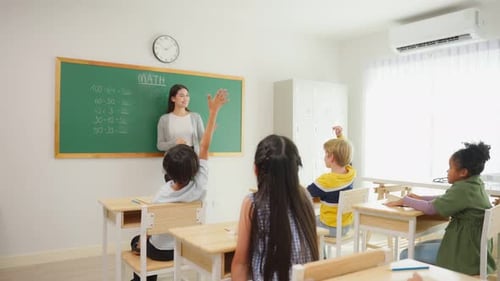 Group of student learn with teacher in classroom at elementary school.
