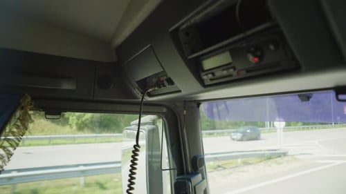 Closeup of a Truck Driver Putting Down a Walkietalkie After Negotiations
