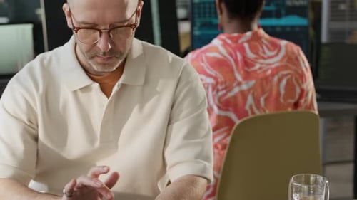 Portrait of Middle-Aged Male Software Engineer Working in Open Space Office