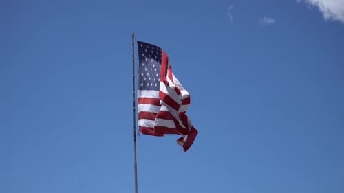 American Flag Waving Proudly in the Blue Sky
