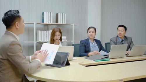 Professionals Analyzing Data at Modern Business Meeting