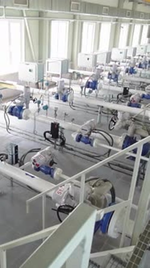 Natural gas pumping station with industrial pipes, valves, and equipment in a clean facility