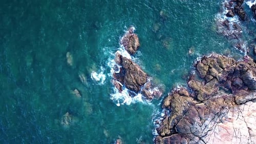 Aerial Top view of a transparent blue sea with beautiful waves at sunny day in summer. air of ocean