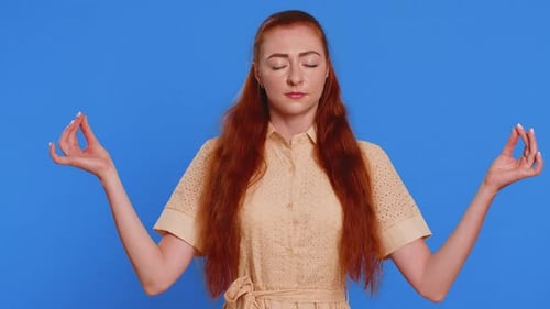 Woman Meditating on Blue Background