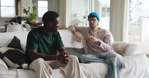Two Men Chatting on Sofa at Modern Home