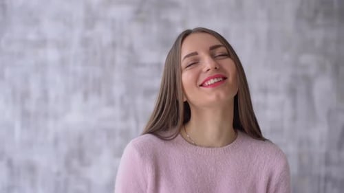 Happy Young Woman Smiling in Pink Sweater