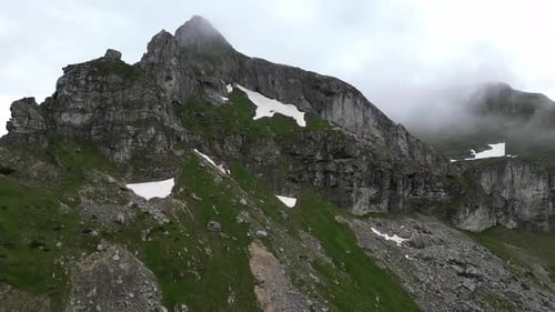 Epic rock in the clouds. Aerial view. Incredible mountain panorama. Mountains in the clouds.