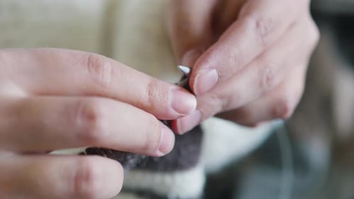 Close Up of Hands Knitting with Yarn
