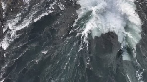 Overhead drone view of Selfoss waterfall in Iceland with intense water flow and crashing waves.