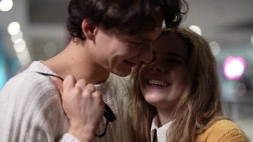 Smiling Couple Embracing in Urban Setting