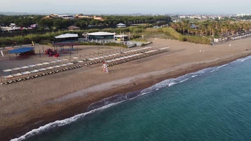 Aerial sun loungers and lifeguard tower on the beach 4K