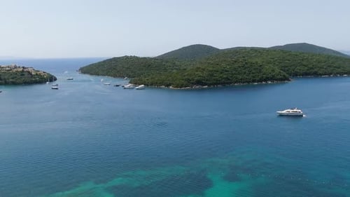 Aerial View of Calm Blue Bay with Anchored Yachts and Boats near Green Islands in Corfu Greece