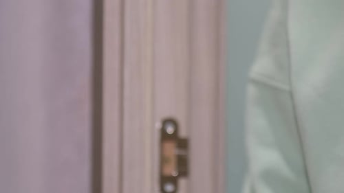 Girl in a Burgundy Hoodie Opens the Door Leaves the Room a Woman Carefully Closes the Door Side View