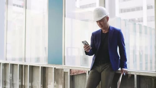Architect Using Phone in Empty Office Space Adult