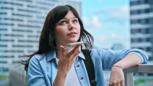 Young Woman Recording Audio Message on Smartphone Outdoors Street Urban Style