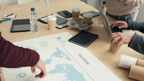 Business Team Analyzing Global Statistics at Workplace