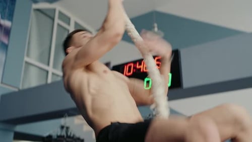 Person Climbing Rope in Gym Focus on Hands and Rope