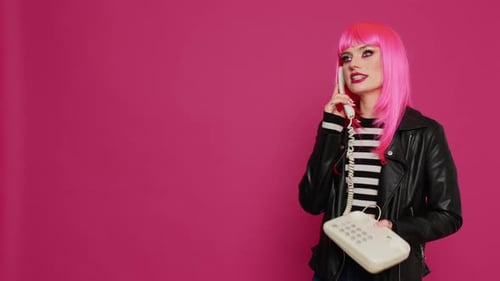 Attractive Woman with Pink Wig Talking on Landline Phone Call
