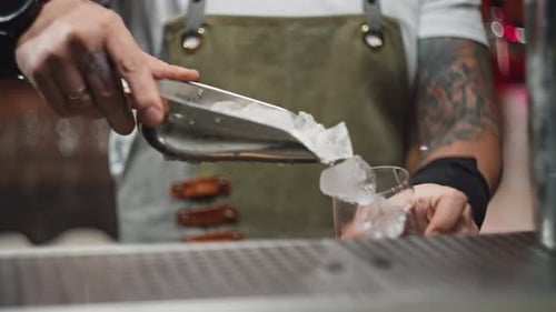 Bartender Fills Glass with Ice at Urban Bar