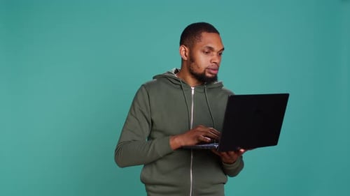 Man Typing on Laptop Keyboard Checking Emails Overjoyed By Good News