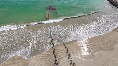 Drone High Flyover A Fishing Net Being Pulled Ashore 5