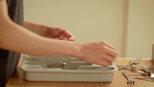 Forks Placing Into Plastic Tray Unrecognizable Person Sorting Cutlery on Wooden Table Hands