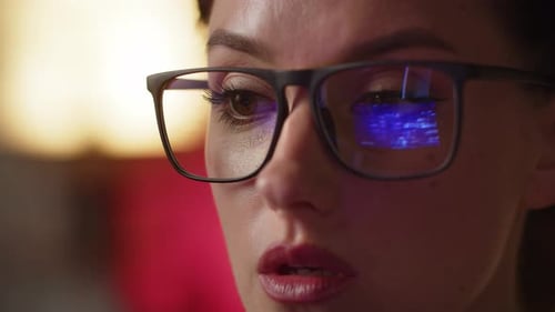 Close Up of Trader Analyzing New Information on Pc Monitor with Glasses Reflection Confident