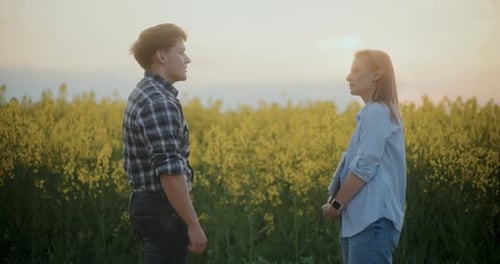 Farmer And Agronomist Discussing By Plants In Farm
