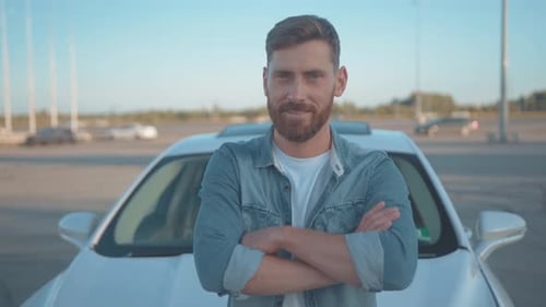 Confident Man Standing in Front of Car Smiling
