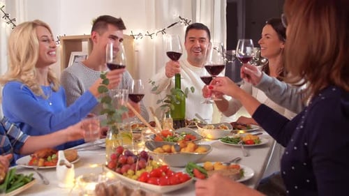 Family and Friends Toast Wine at Dinner Party