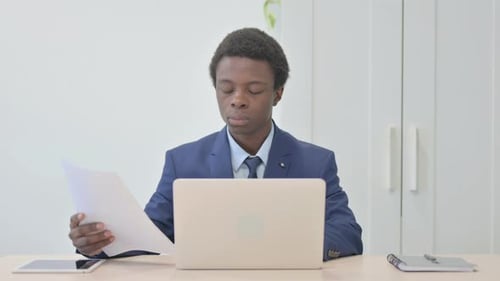 Young Adult Celebrates Success at Desk