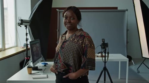 Portrait of Young Female Photographer at Work in Studio