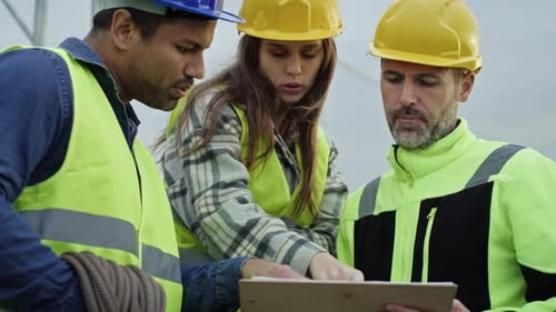 Engineers Discussing Wind Turbine Construction and Maintenance