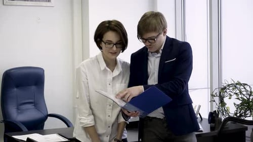 Business Colleagues Analyzing Documents in Office
