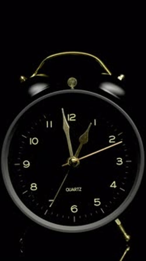 Time lapse of a black alarm clock ticking