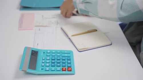 Budgeting and Calculating Finances with Calculator and Cash