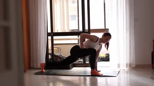 Woman Practicing Yoga on Mat in Bright Home