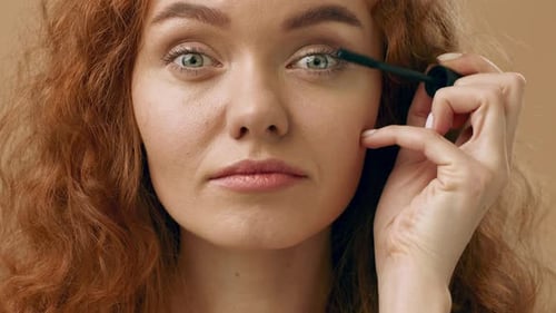 Woman Applies Mascara in a Beauty Close Up