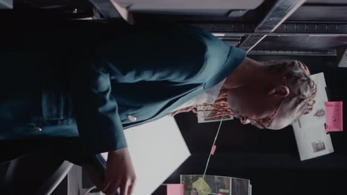 Adult Looking at Crime Board With Photos