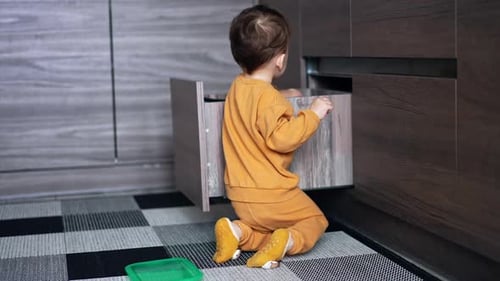 Infant Plays With Kitchen Drawer Items