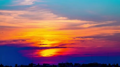 Sunset in a Cloudy Sky over City Rooftops